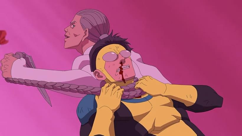 Animated scene depicting an older woman in a white coat strangling a younger, yellow-suited character with dark hair. The younger character has blood streaming from their nose and appears to be struggling. The older woman has a determined expression and holds a knife behind the younger character. Invincible Spoiler-Free Review.