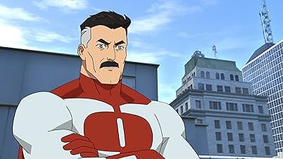 Still from "Invincible Spoiler-Free Review" showing the character Omni-Man, drawn in a classic comic book style, with a stern expression, arms crossed, wearing his white and red superhero suit; modern skyscrapers rise behind him.