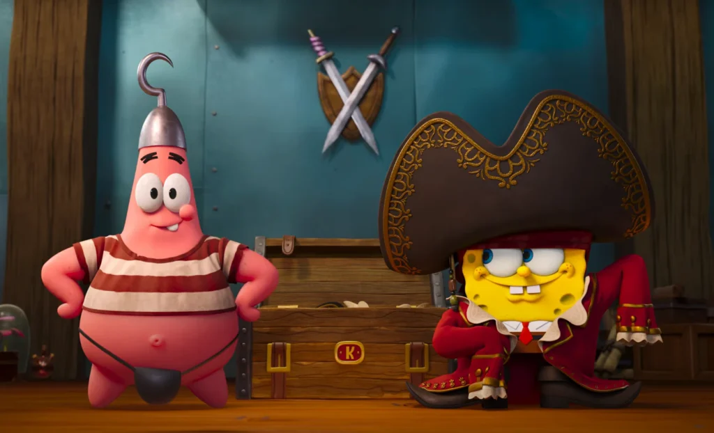 SpongeBob movie 2025 trailer still depicting SpongeBob, dressed as a pirate, and Patrick Star, with a hook on his head, both smiling, standing in front of a wooden chest with a "K" emblem, set against a nautical-themed backdrop with crossed swords.