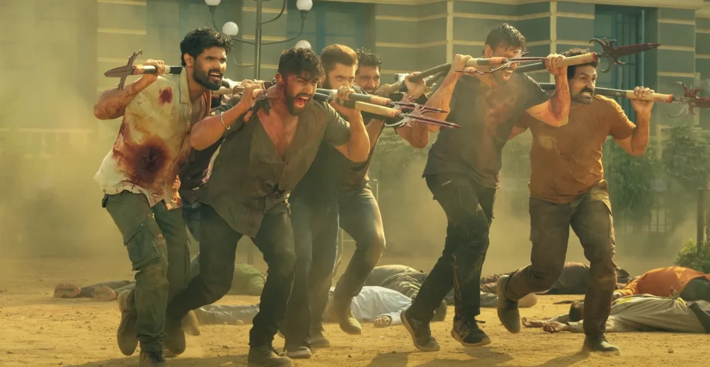 A scene potentially related to the Sikandar piracy leak shows several individuals carrying weapons, appearing to be spears with multiple sharp edges, on their shoulders while running, with intense expressions on their faces and what appears to be dirt or blood on their clothing.