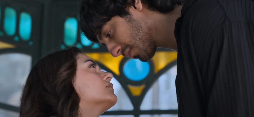 Close-up of a man and woman facing each other with solemn expressions.