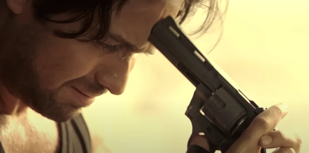 Emraan Hashmi in Awarapan 2, close-up, holding a gun to his head with a disturbed expression.