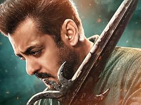 Close-up of a Salman Khan holding a large antique weapon, looking intense, for sikandar movie review.