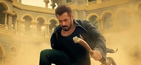 Indian actor Salman Khan wielding an axe with a determined expression, possibly representing legal action stemming from Bollywood piracy scandals.