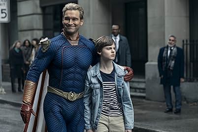 Homelander, portrayed by Antony Starr, smiles with his arm around a young boy wearing a jean jacket, while walking down a city street. Behind them is a row of people, including two men in suits.