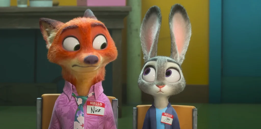 From the Zootopia 2 Trailer Nick Wilde, a fox, and Judy Hopps, a rabbit, are seated next to each other wearing name tags in what seems to be a serious meeting. Nick wears a floral patterned shirt and a tie, looking inquisitive. Judy Hopps wears darker, businesslike attire and appears concerned or skeptical.