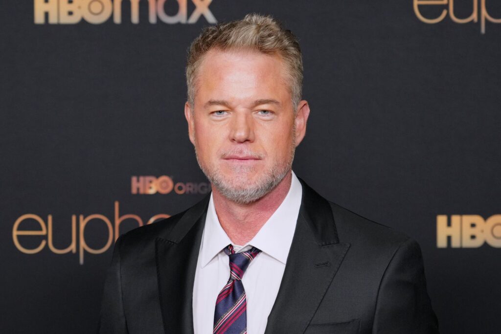 Actor Eric Dane wearing a black suit and patterned tie, posing at the HBO Original Euphoria season 2 premiere red carpet event. Eric Dane Death ALS